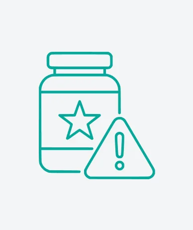 A jar of pills next to a warning sign, indicating caution regarding medication use and potential side effects.