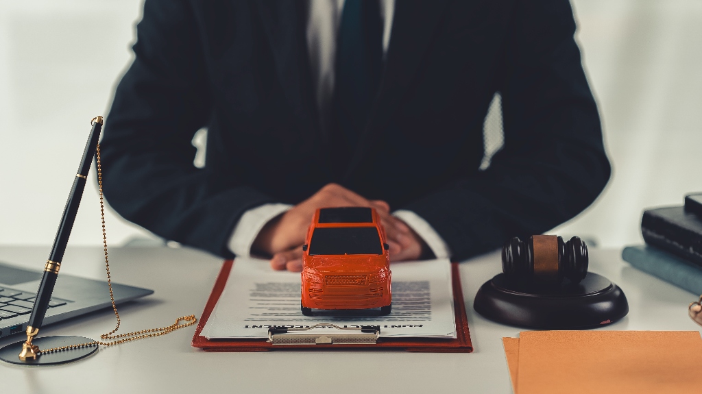 Lawyer with judge's gavel and red toy car