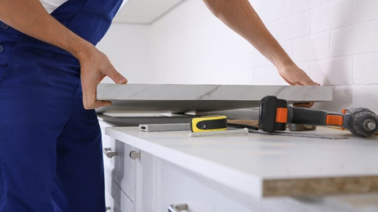 Worker installing new countertop in kitchen