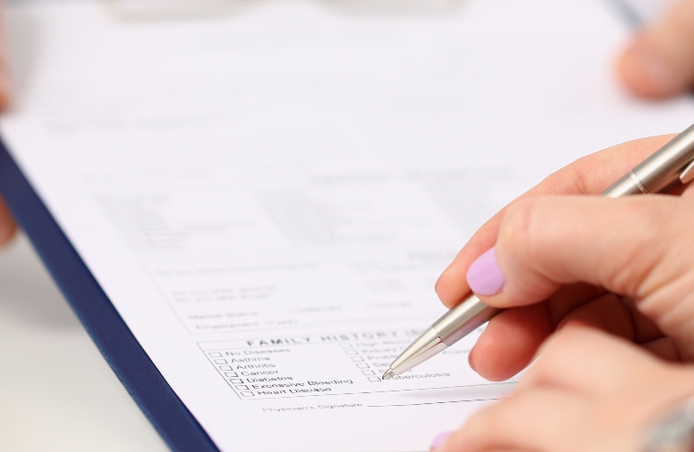 woman is signing documents